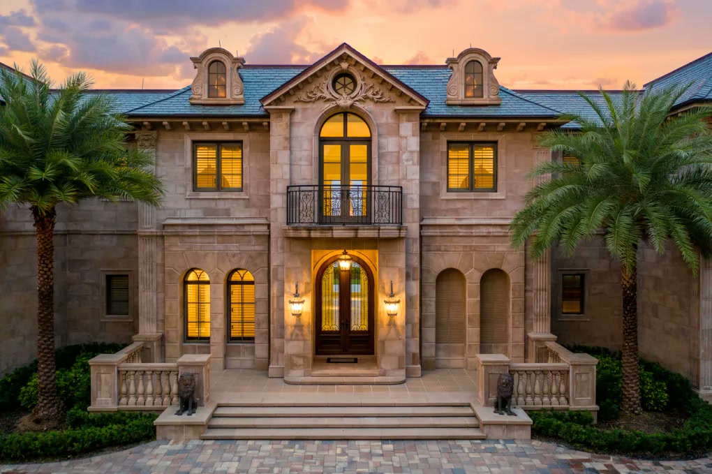 Illuminated stone entry and symmetrical front facade
