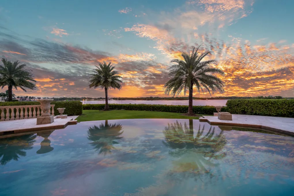 Stone terrace and reflecting pool beneath a Naples sunset