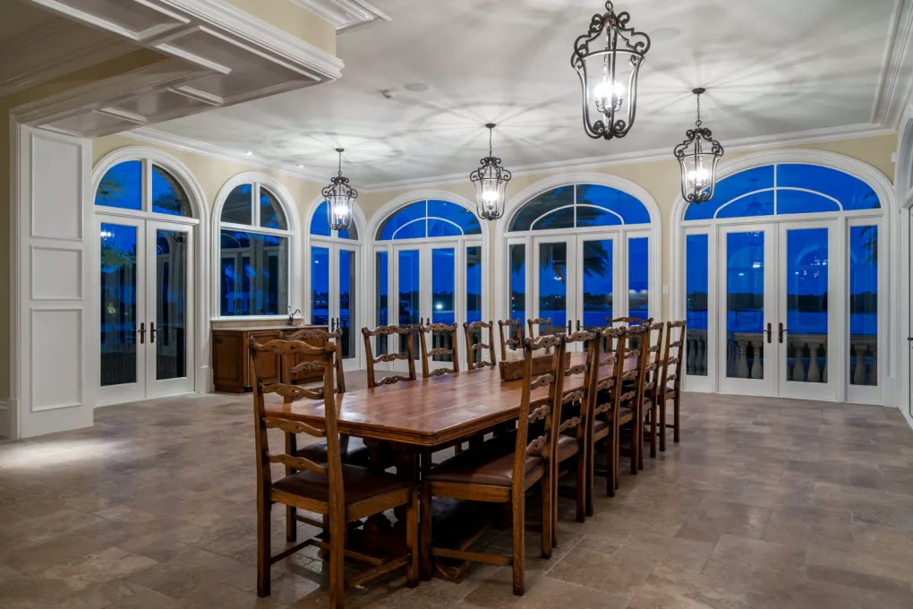 Formal dining room with arched windows facing the water