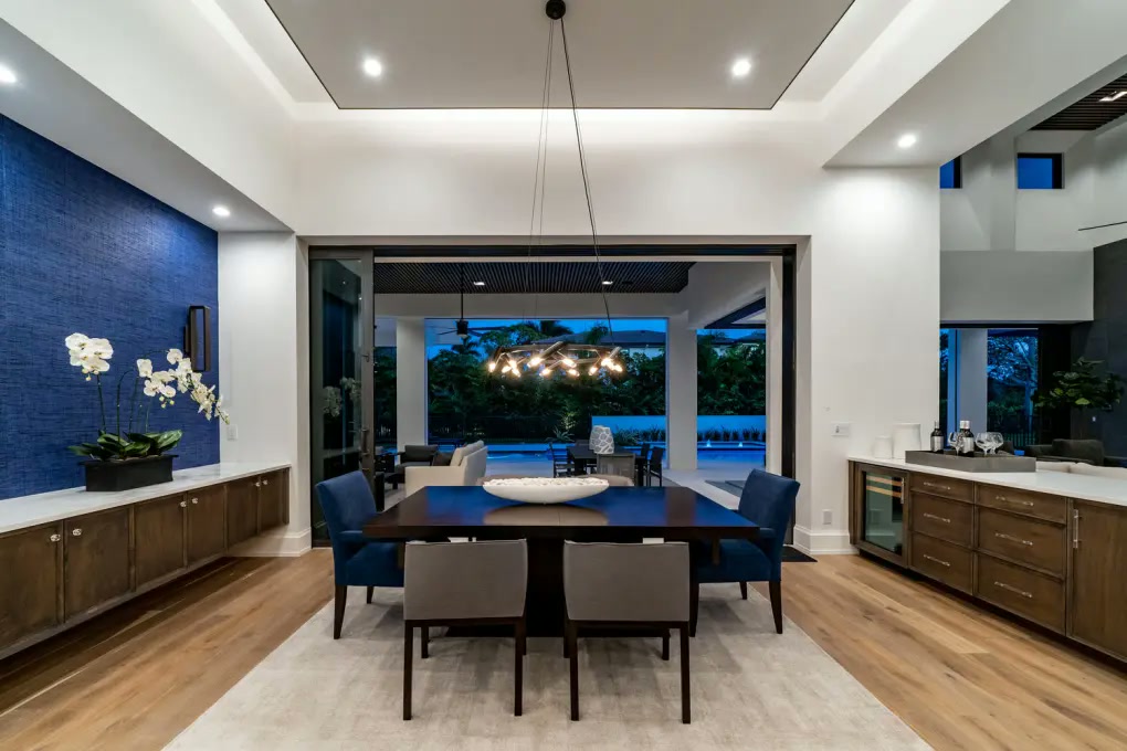 Contemporary dining room opening to a covered terrace
