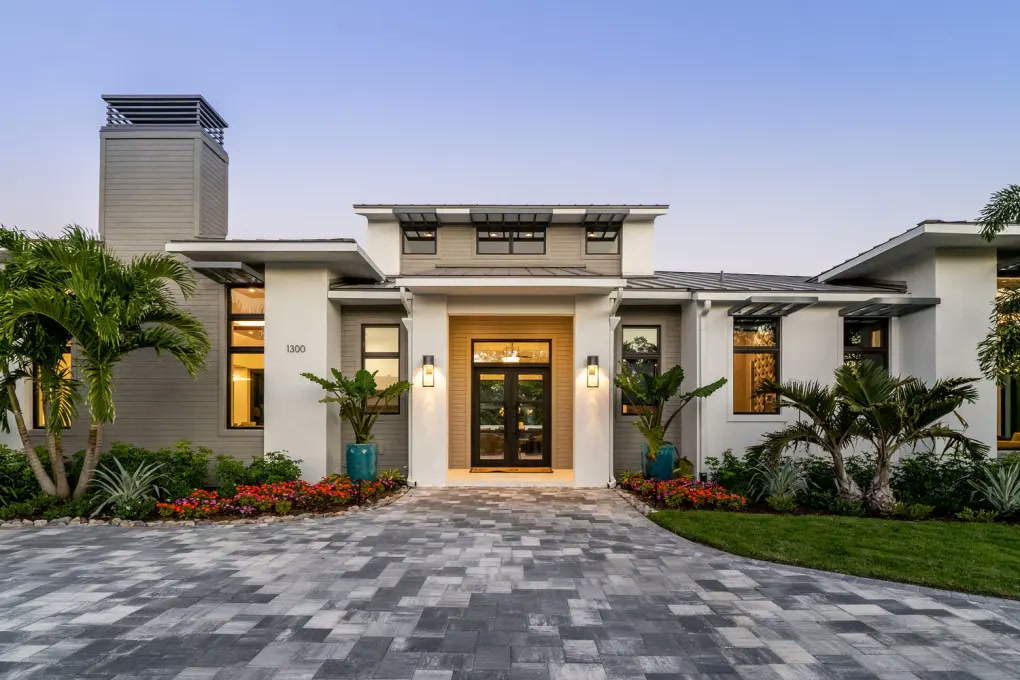 Modern Naples residence with a symmetrical landscaped entry