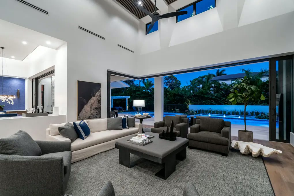 Double-height living room opening directly to the pool