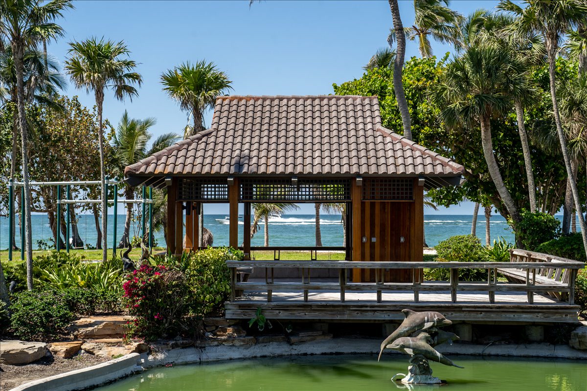 Open pavilion overlooking a garden pond near the Gulf