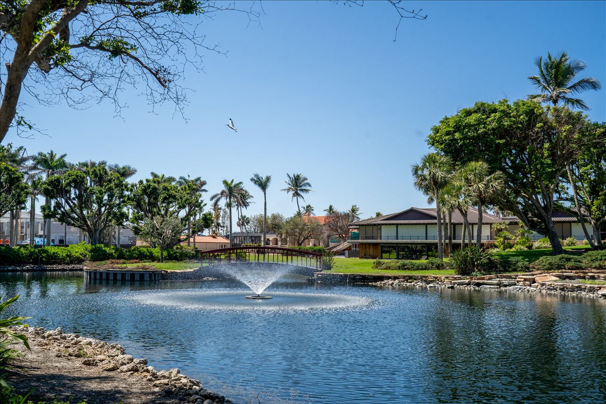 Landscaped lake with fountain, bridge, and pavilion