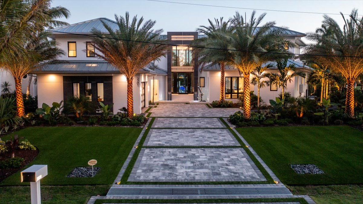 Landscaped modern front elevation and long paved approach