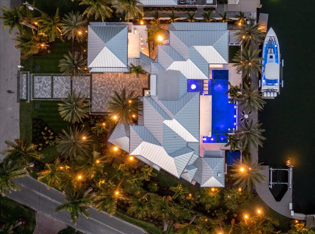Top-down evening aerial showing the estate, pool, and dock
