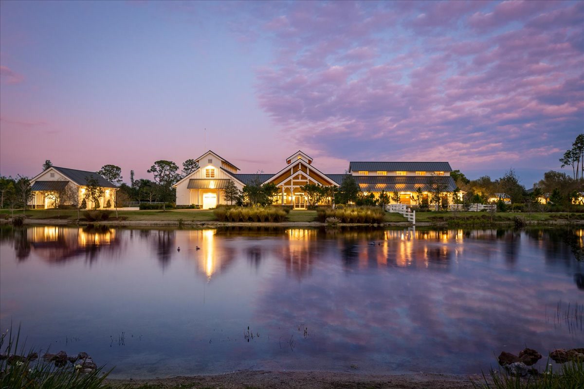 Lakeside property reflected in calm water at twilight